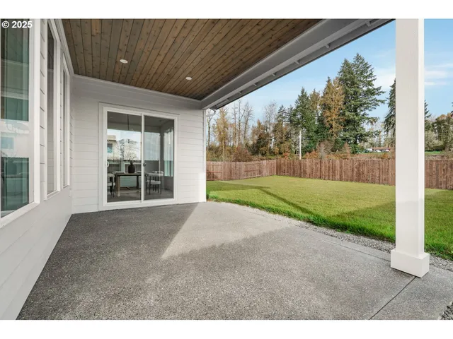 a view of a house with backyard and porch