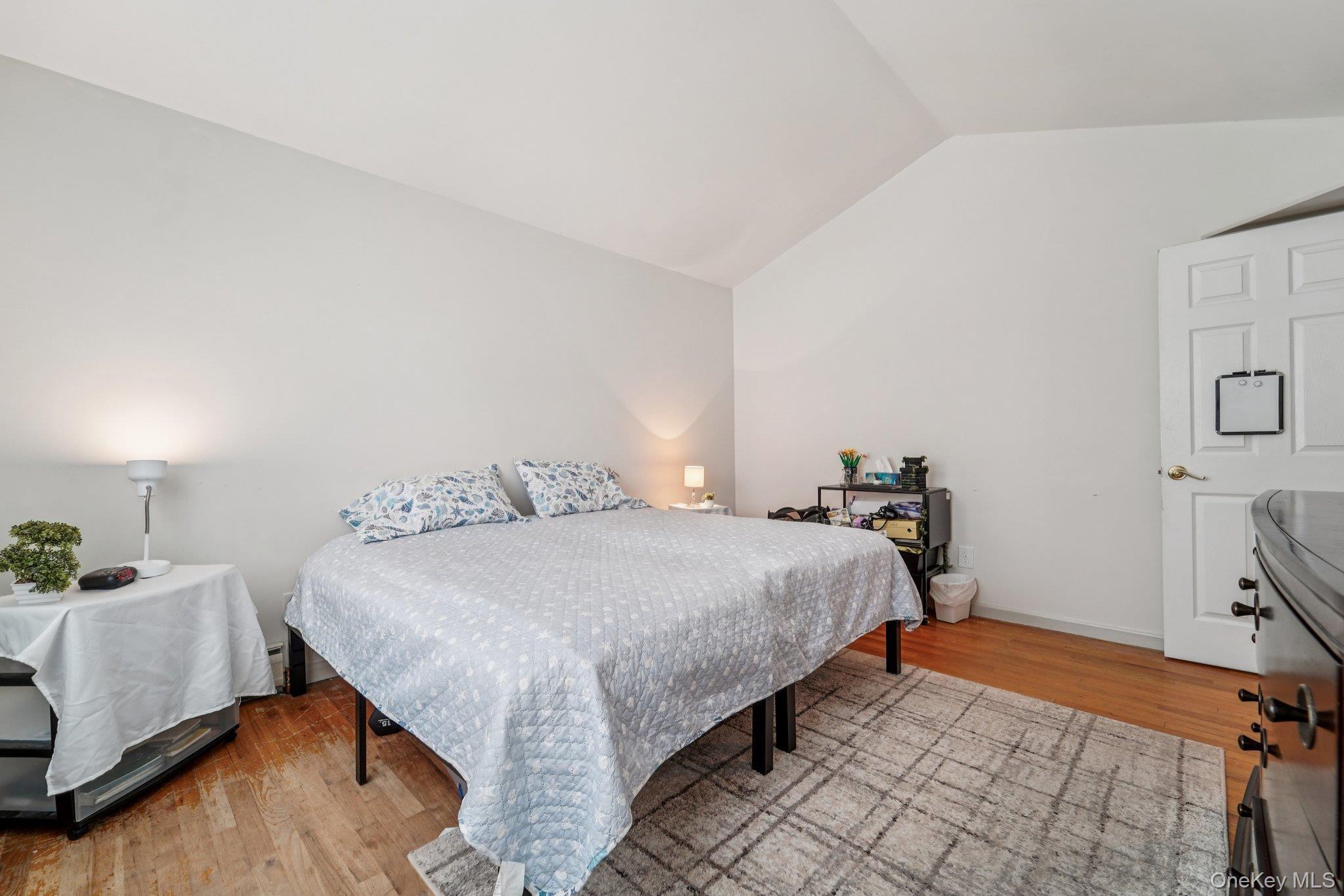 10 Ward Street Suffern, NY 10901 - Photo 19 of 34 Bedroom with vaulted ceiling and wood finished floors