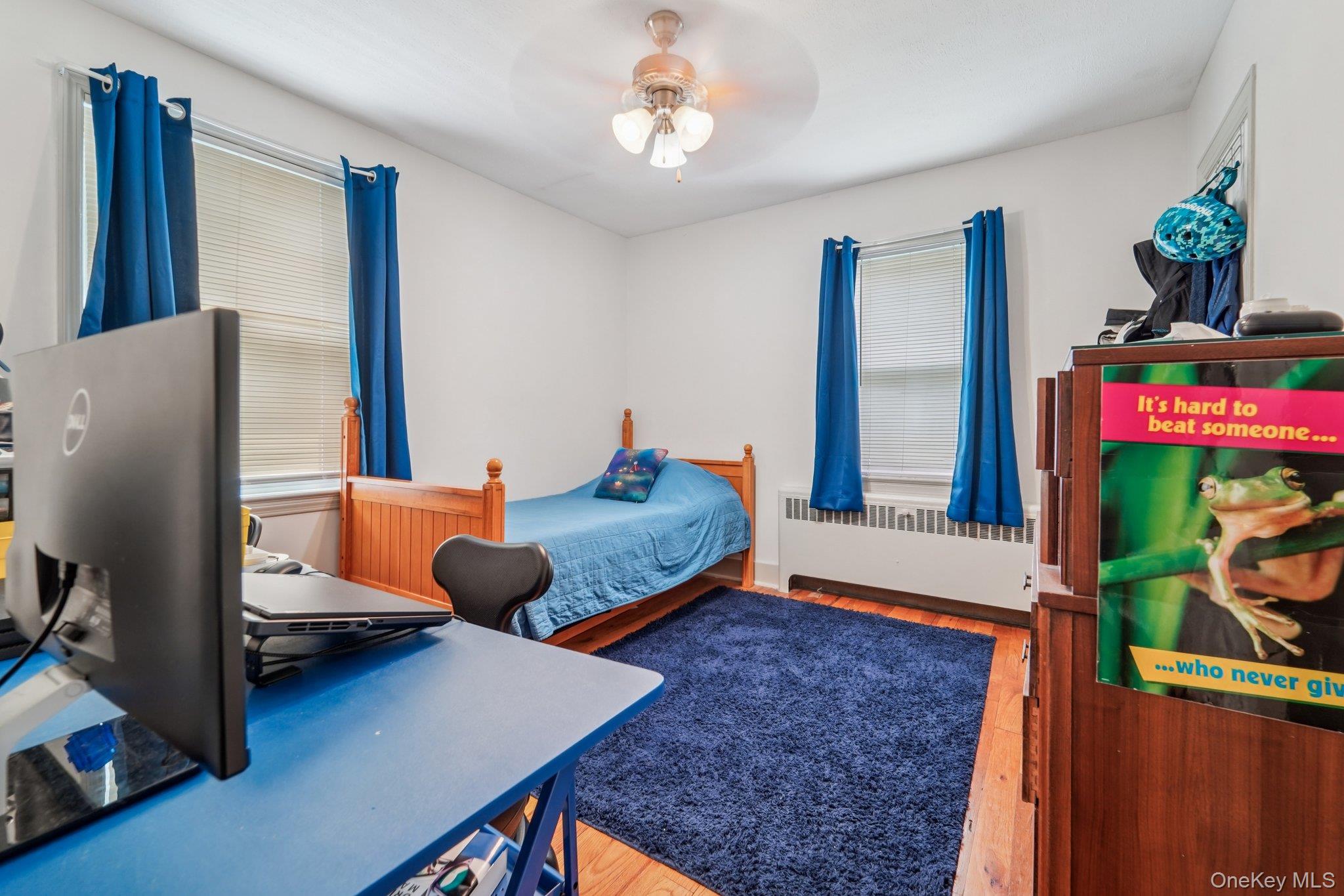 10 Ward Street Suffern, NY 10901 - Photo 22 of 34 Bedroom with radiator heating unit, wood finished floors, a desk, and ceiling fan