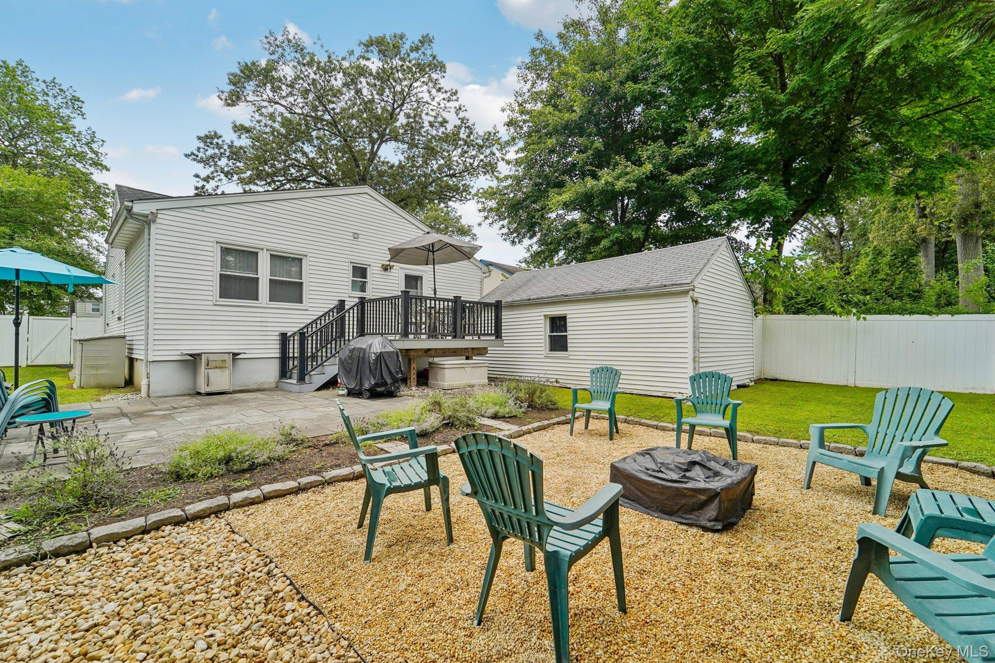 10 Ward Street Suffern, NY 10901 - Photo 30 of 34 Rear view of property with a fire pit, a patio, a wooden deck, and a fenced backyard
