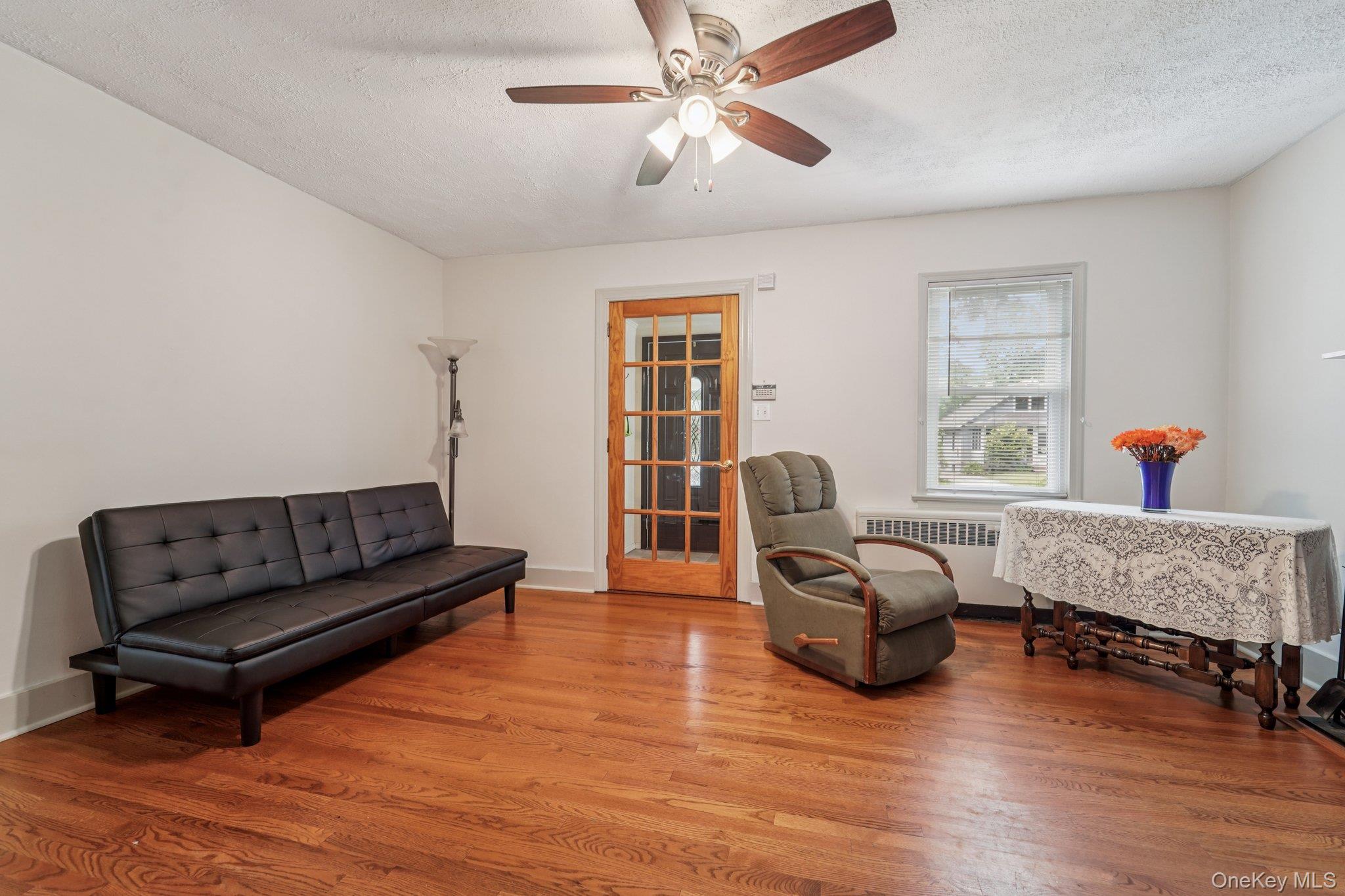 10 Ward Street Suffern, NY 10901 - Photo 7 of 34 Sitting room featuring radiator, wood finished floors, a textured ceiling, and a ceiling fan