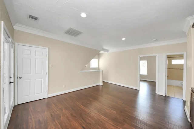 wooden floor in an empty room with a window