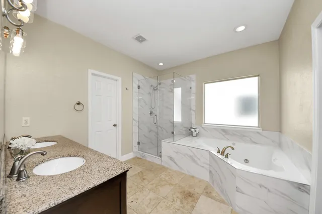 a bathroom with a bathtub and a window