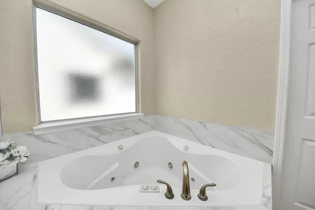 a view of walk in closet with wooden floor and cabinets