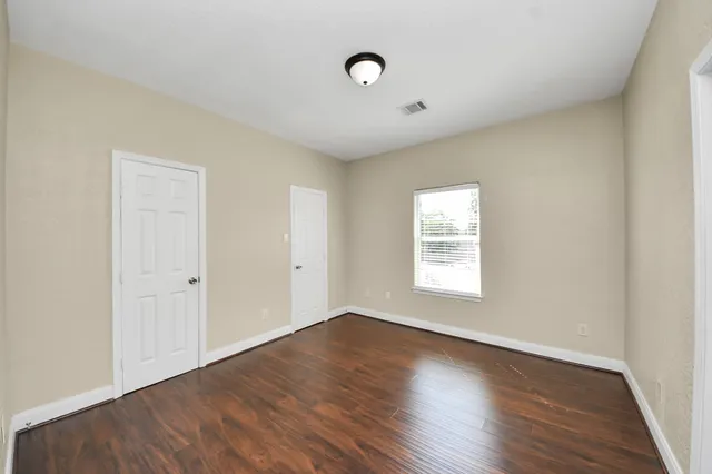a bathroom with a granite countertop sink a toilet a mirror and shower