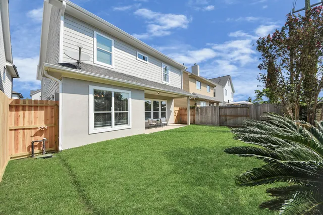 a house view with a sitting space and garden