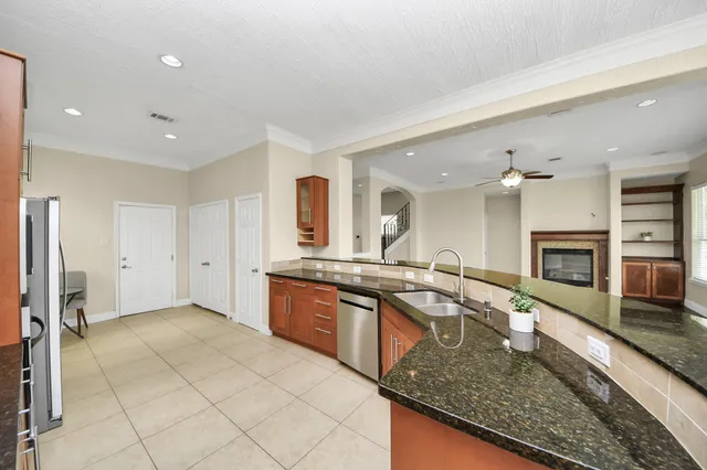 a kitchen with stainless steel appliances granite countertop a stove and a refrigerator