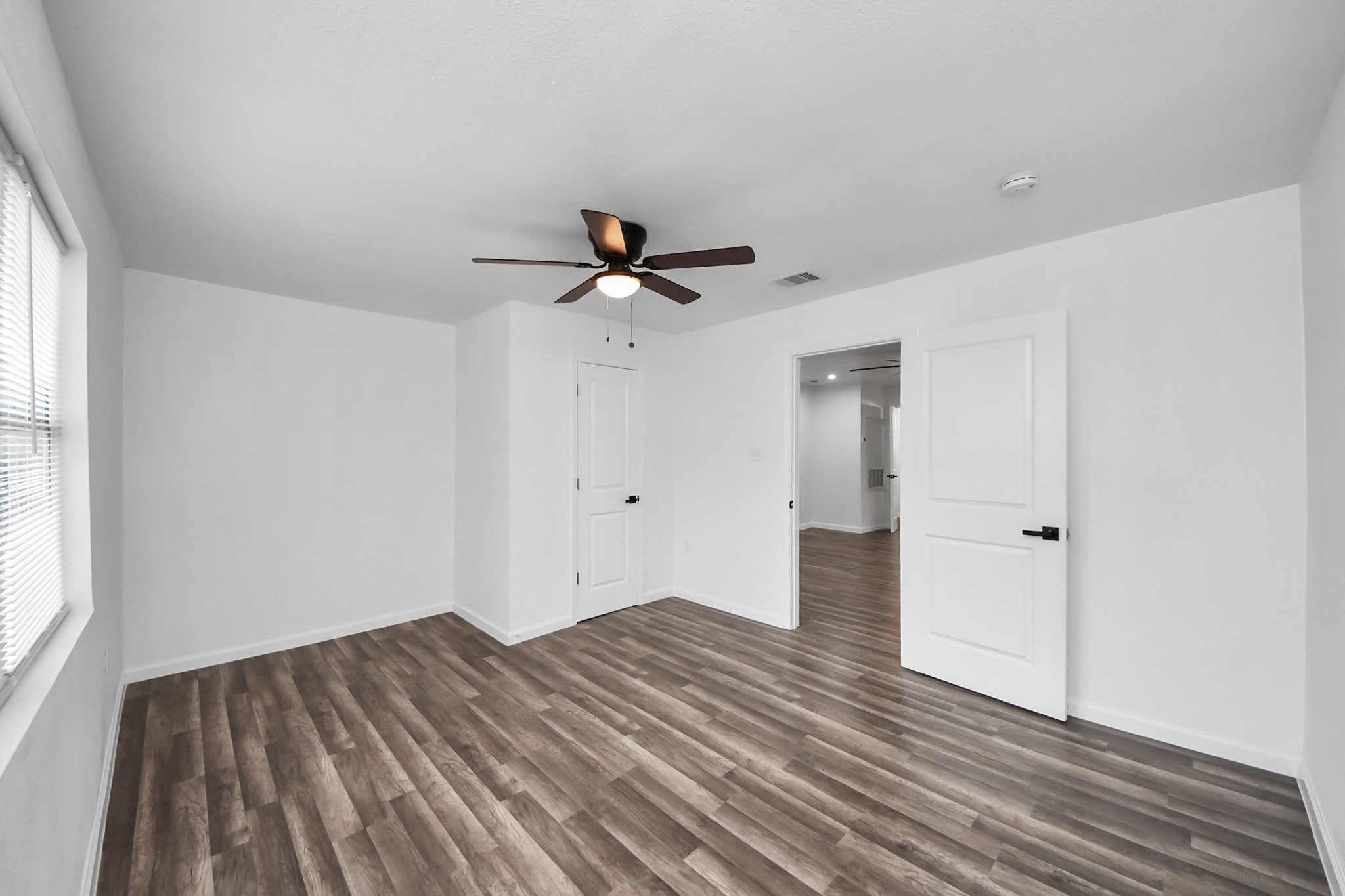 207 East Defee Avenue Baytown, TX 77520 - Photo 25 of 36 a view of empty room with wooden floor and fan