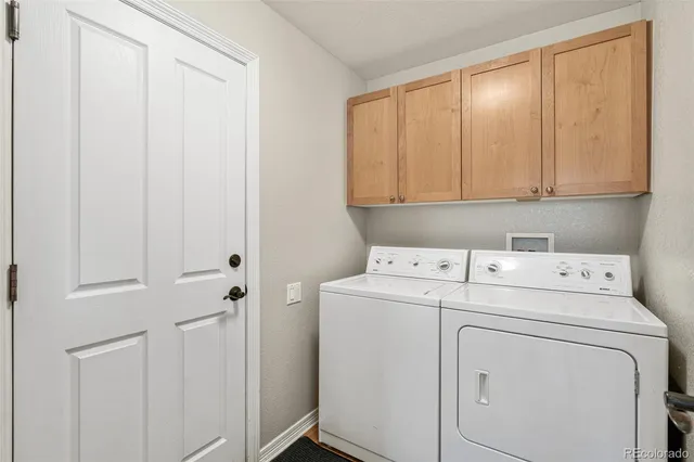 an empty room with granite countertop cabinets and a kitchen