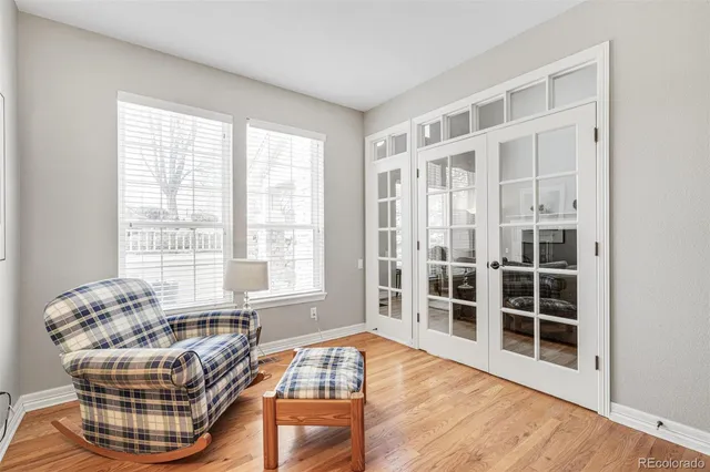 a living room with furniture windows and wooden floor