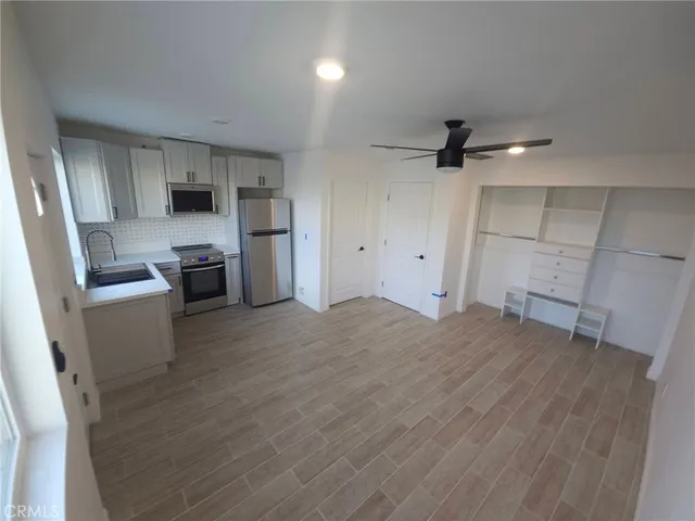 a view of a kitchen with a sink and a refrigerator