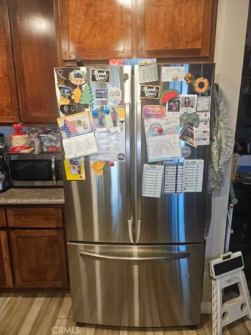 a utility room with fridge dryer and washer