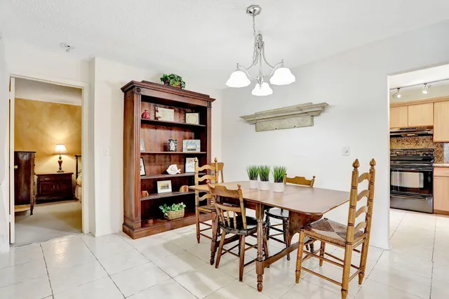 a view of a dining room with furniture and a chandelier