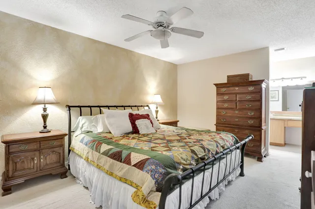 a bedroom with a bed and dresser