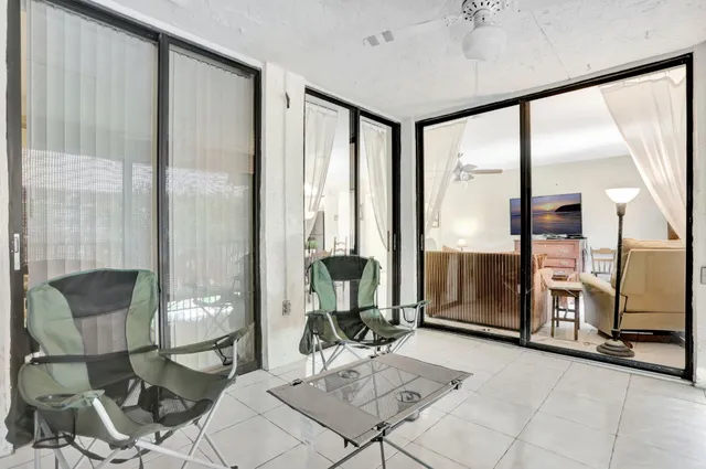 a living room with furniture and large windows