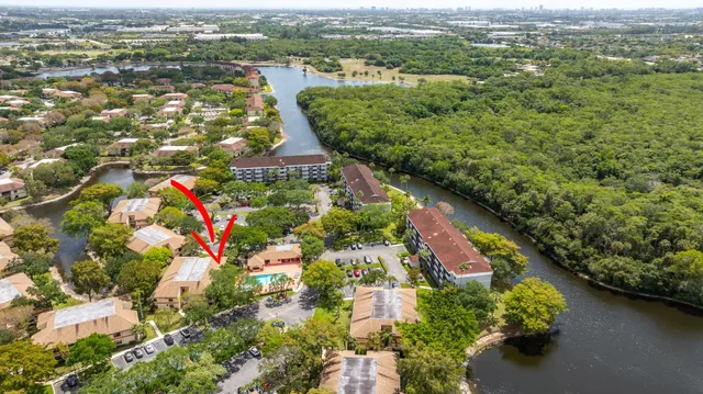 an aerial view of residential houses with outdoor space and river view
