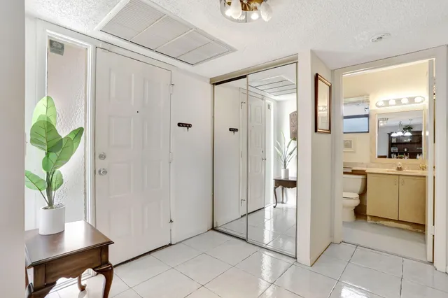 a hallway with cabinets and wooden floor
