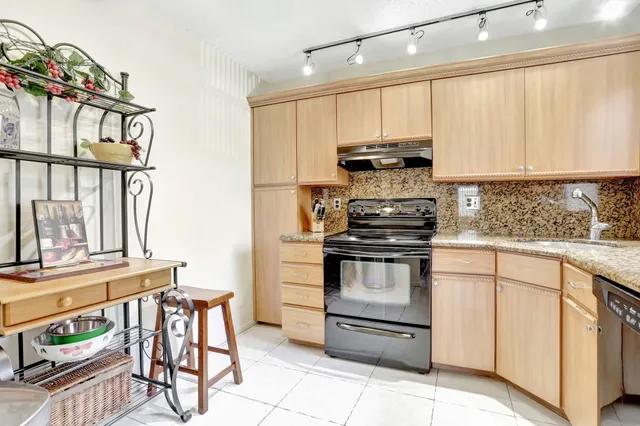a kitchen with a stove a sink and a microwave