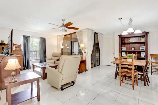 a living room with furniture and a book shelf