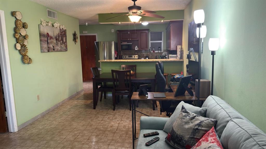 3181 Southwest 13th Street, Unit 114 Miami, FL 33145 - Photo 13 of 17 a living room with furniture and a chandelier