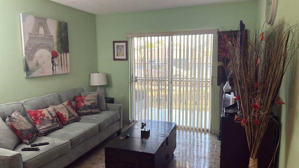 3181 Southwest 13th Street, Unit 114 Miami, FL 33145 - Photo 14 of 17 a living room with furniture and a window