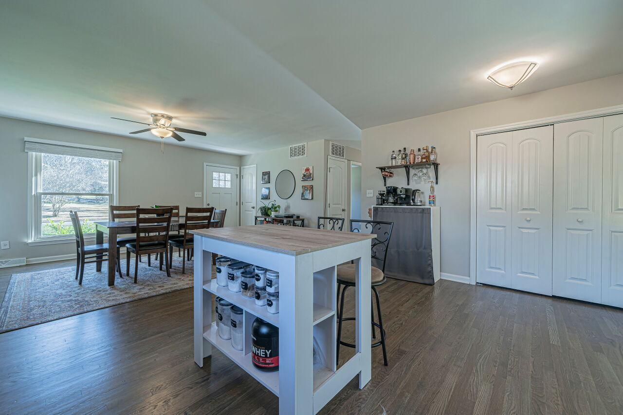 3322 Bell Drive Raleigh, NC 27610 - Photo 11 of 35 a kitchen with kitchen island wooden floor and refrigerator