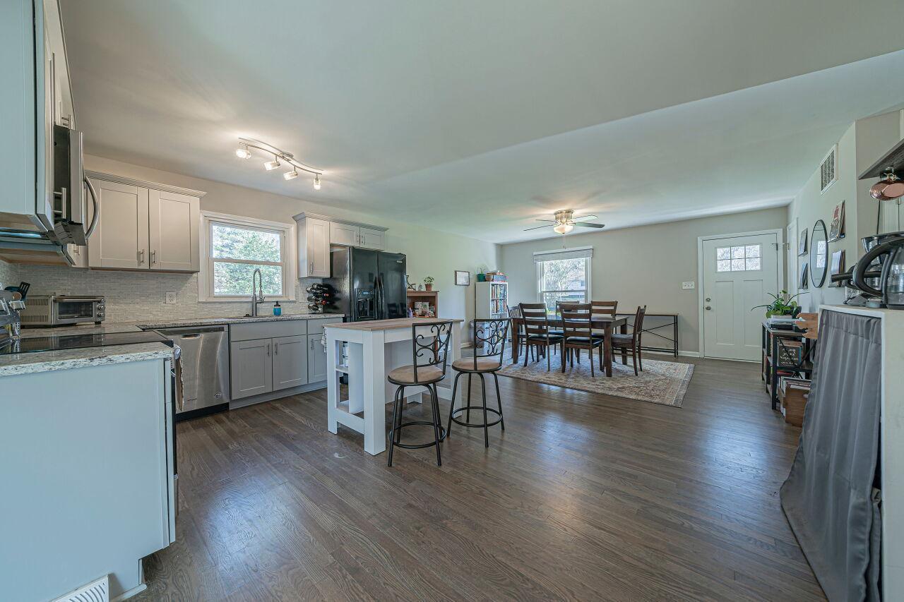 3322 Bell Drive Raleigh, NC 27610 - Photo 13 of 35 a kitchen with a table chairs microwave and cabinets