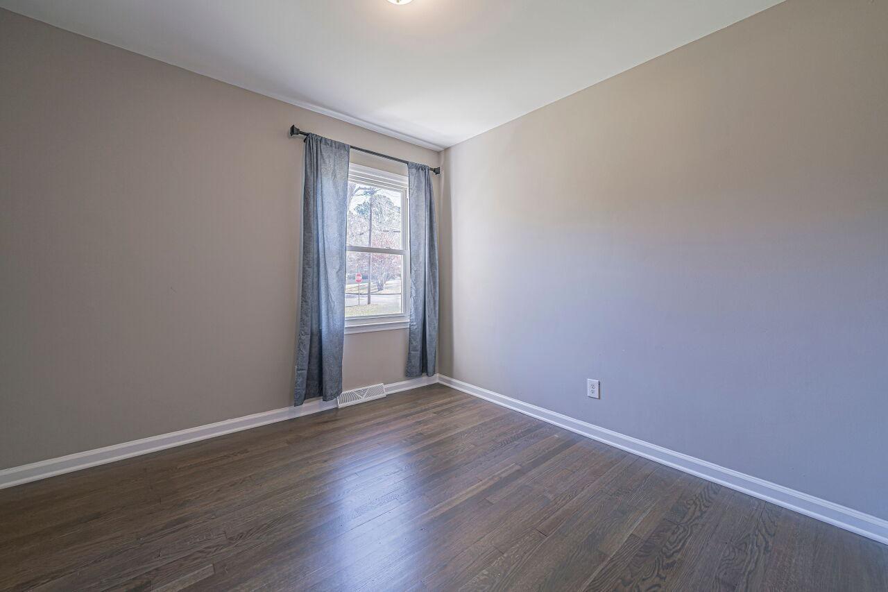 3322 Bell Drive Raleigh, NC 27610 - Photo 19 of 35 a view of an empty room with wooden floor and a window