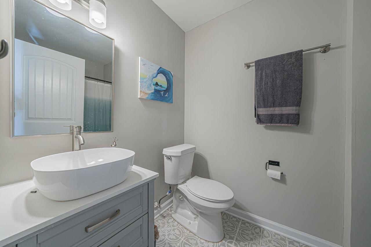 3322 Bell Drive Raleigh, NC 27610 - Photo 26 of 35 a bathroom with a toilet a sink and mirror