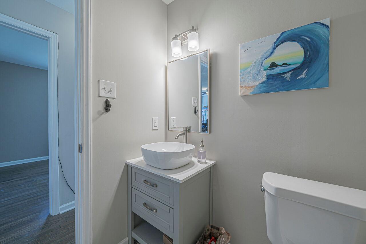 3322 Bell Drive Raleigh, NC 27610 - Photo 27 of 35 a bathroom with a sink toilet and mirror