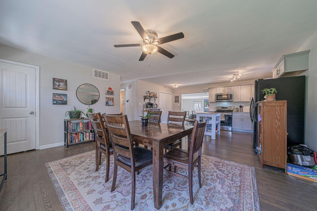 3322 Bell Drive Raleigh, NC 27610 - Photo 9 of 35 a view of a dining room with furniture and wooden floor