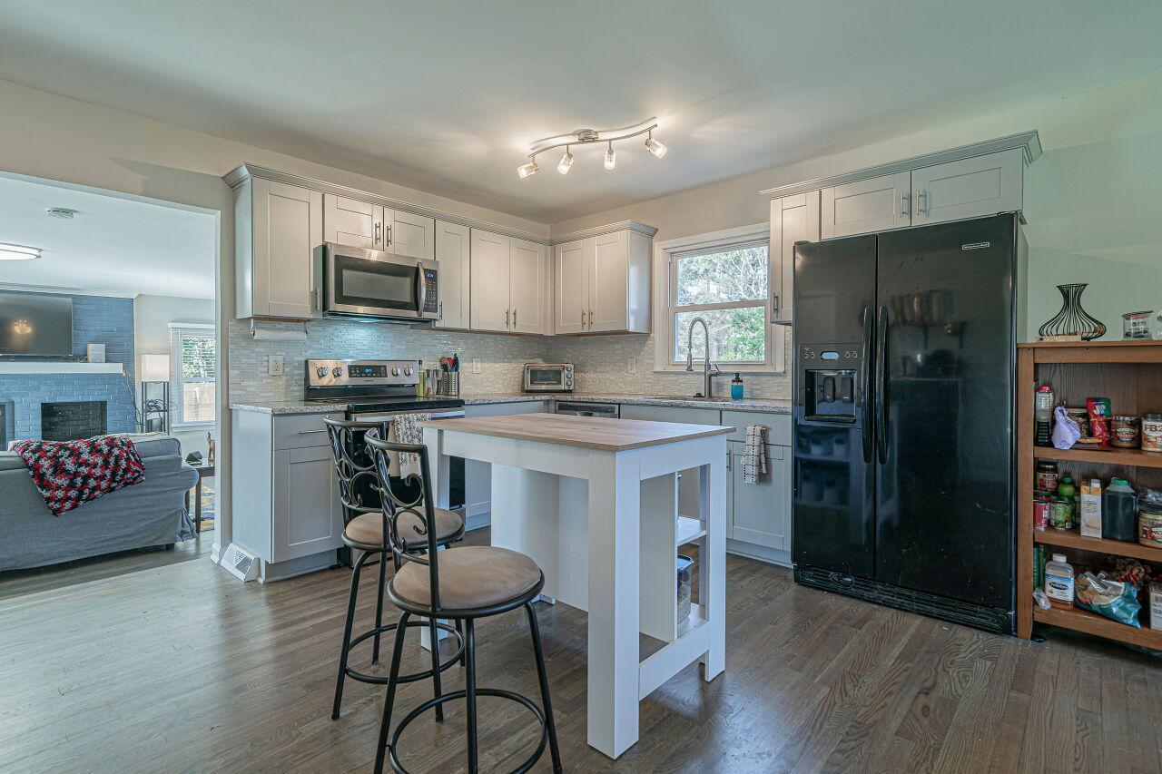3322 Bell Drive Raleigh, NC 27610 - Photo 10 of 35 a kitchen with stainless steel appliances a refrigerator stove microwave and cabinets