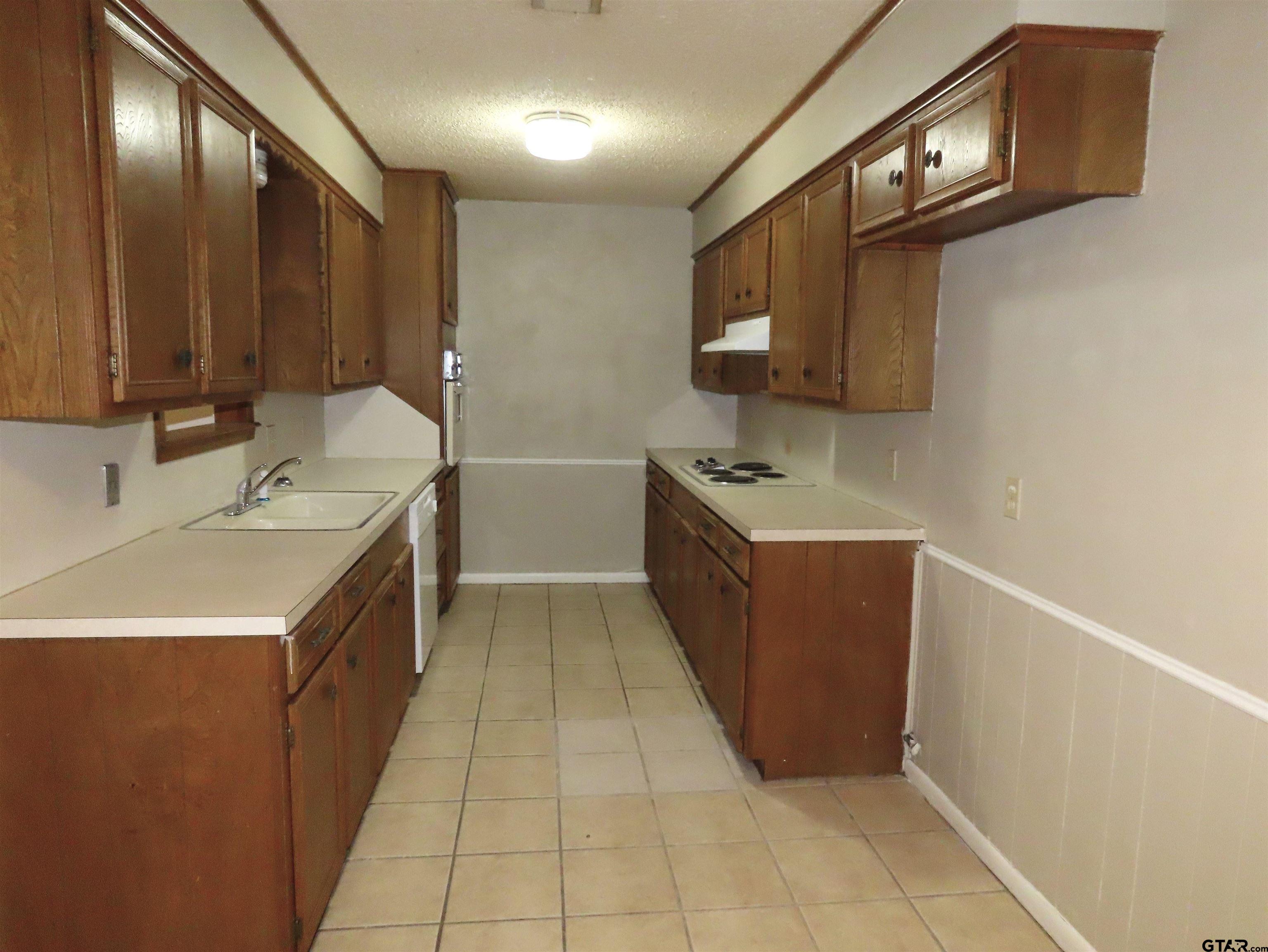 402 Muller Garden Road Tyler, TX 75703 - Photo 12 of 33 a kitchen with stainless steel appliances granite countertop a sink and a stove