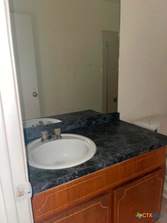 4507 Deek Drive, Unit A Killeen, TX 76549 - Photo 13 of 27 a bathroom with a granite countertop sink and a mirror