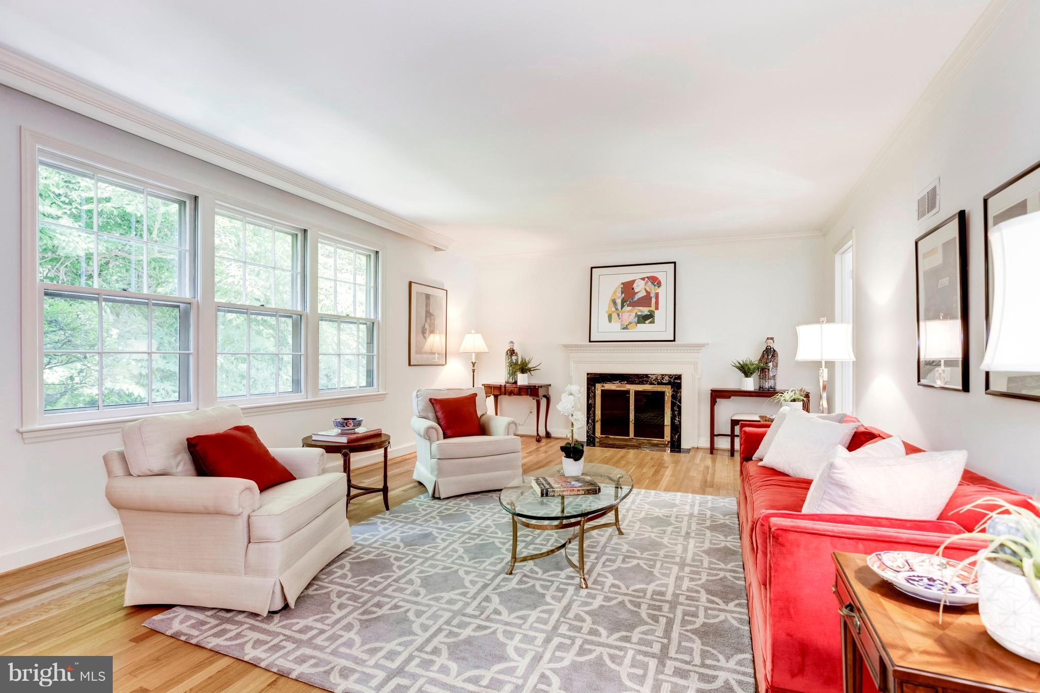 The living room has one of the home's 3 fireplaces