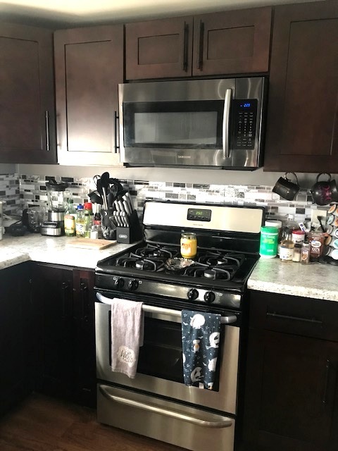 84 Candlegate Circle Matteson, IL 60443 - Photo 13 of 15 a kitchen with granite countertop a stove top oven microwave and cabinets