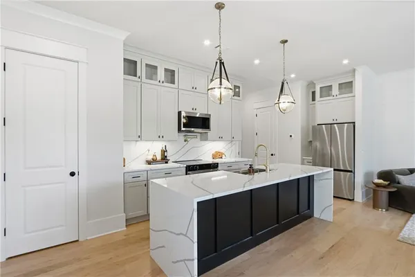 a kitchen with a sink dishwasher and a stove with wooden floor