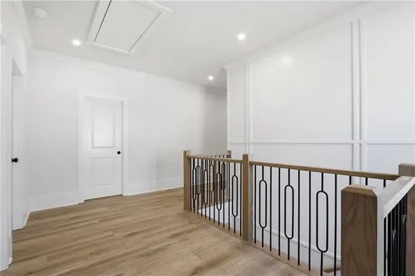 a view of an empty room with wooden floor