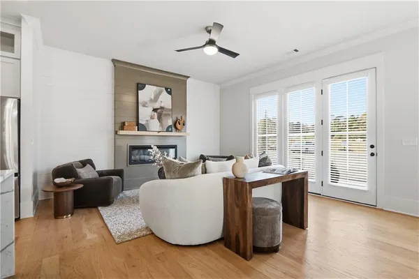 a living room with furniture and large windows