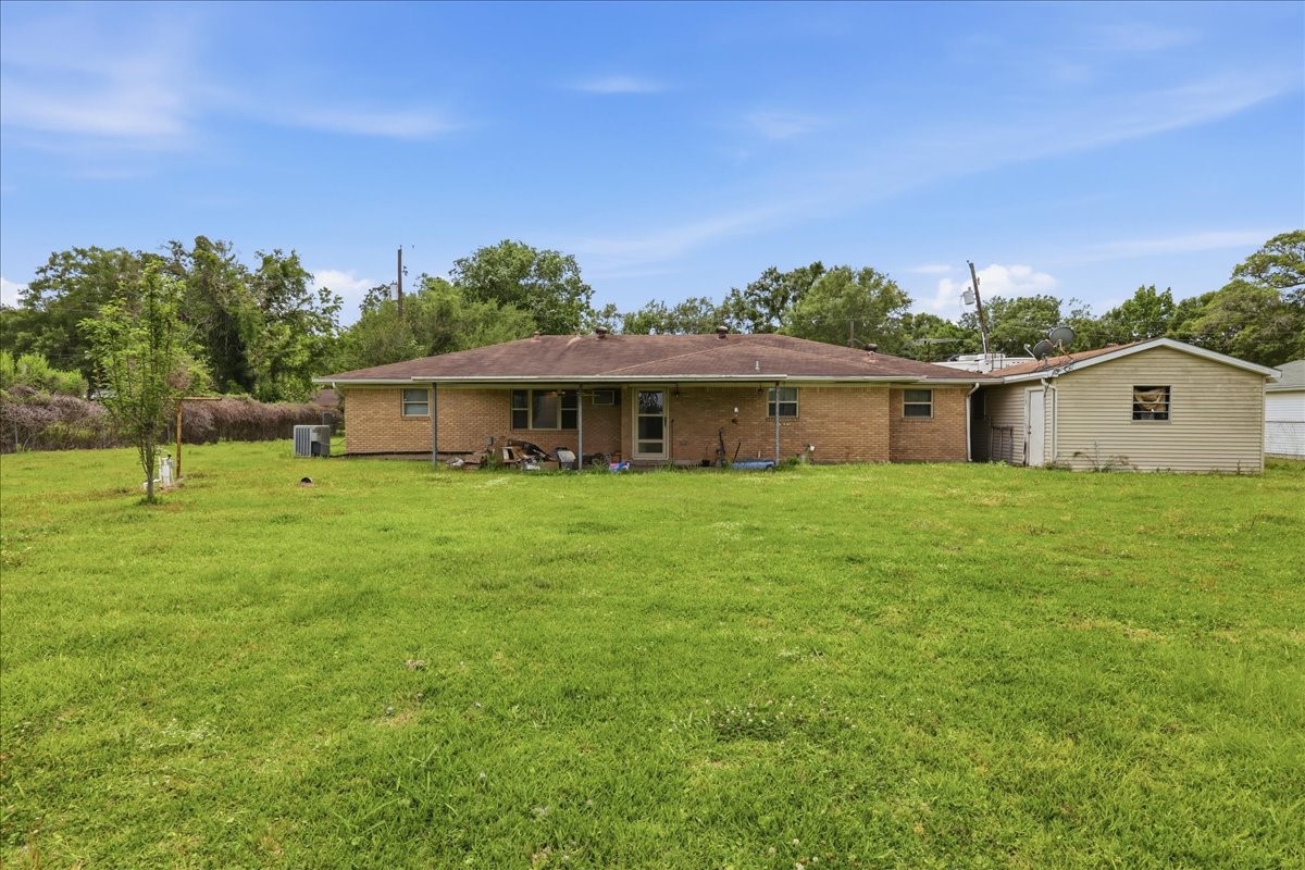 150 Gary Street Bridge City, TX 77611 - Photo 12 of 12 Rear exterior view of home with backyard lawn space.