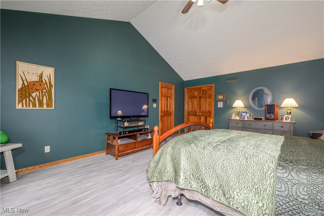 7300 Darrow Road Hudson, OH 44236 - Photo 20 of 44 Main Bedroom with hardwood / wood-style floors, vaulted ceiling, and ceiling fan