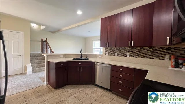 a kitchen with stainless steel appliances granite countertop a refrigerator and a stove