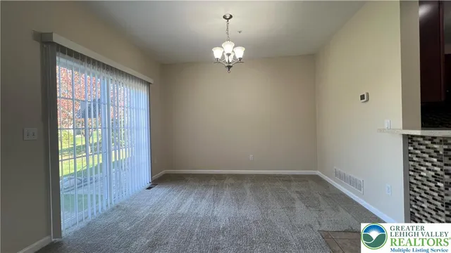 a view of a chandelier in big room and chandelier