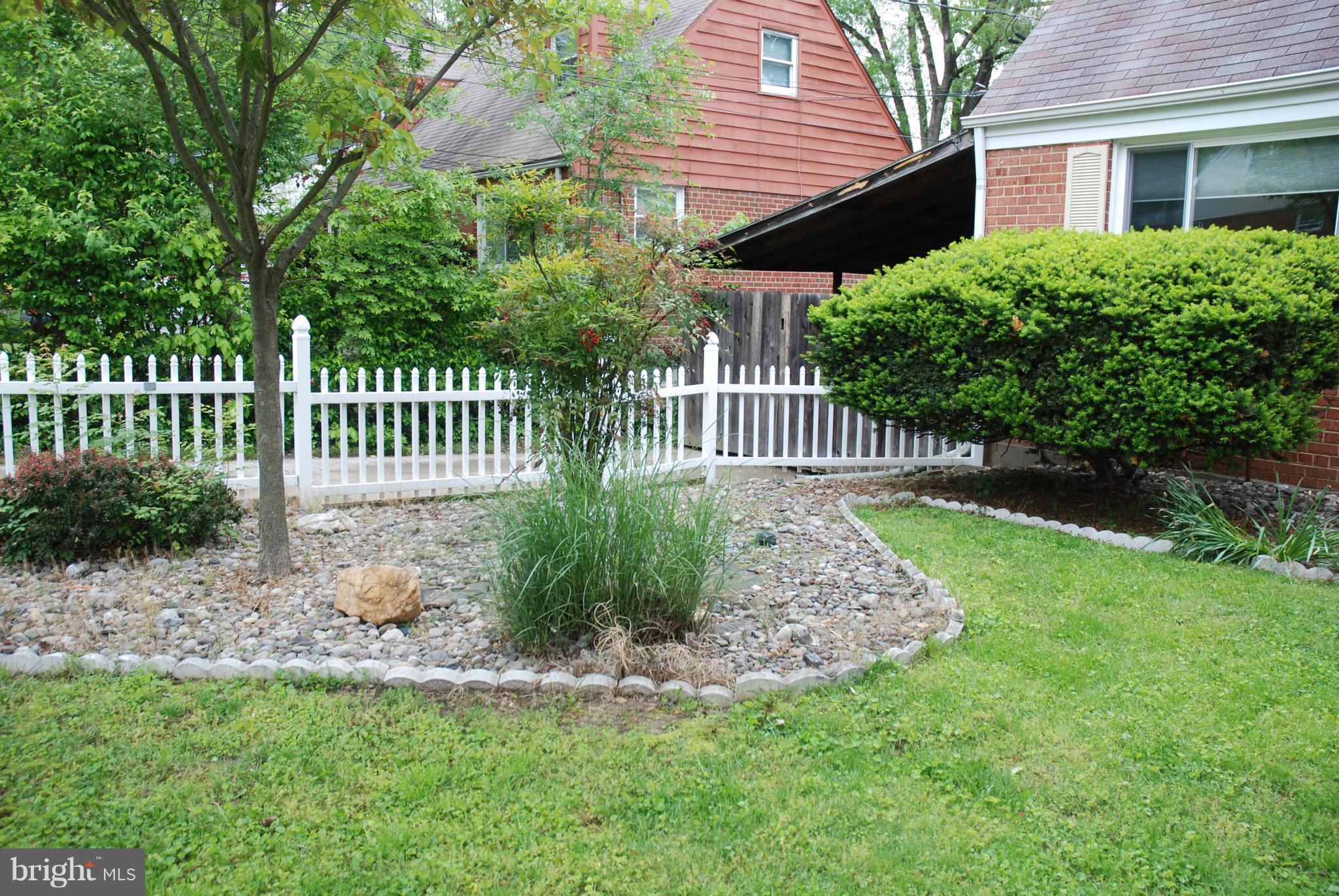 12603 Bluhill Road Silver Spring, MD 20906 - Photo 2 of 21 a front view of a house with a garden