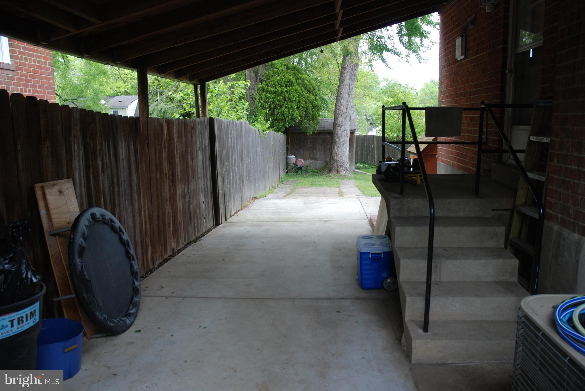 12603 Bluhill Road Silver Spring, MD 20906 - Photo 4 of 21 a view of a porch with wooden floor and roof