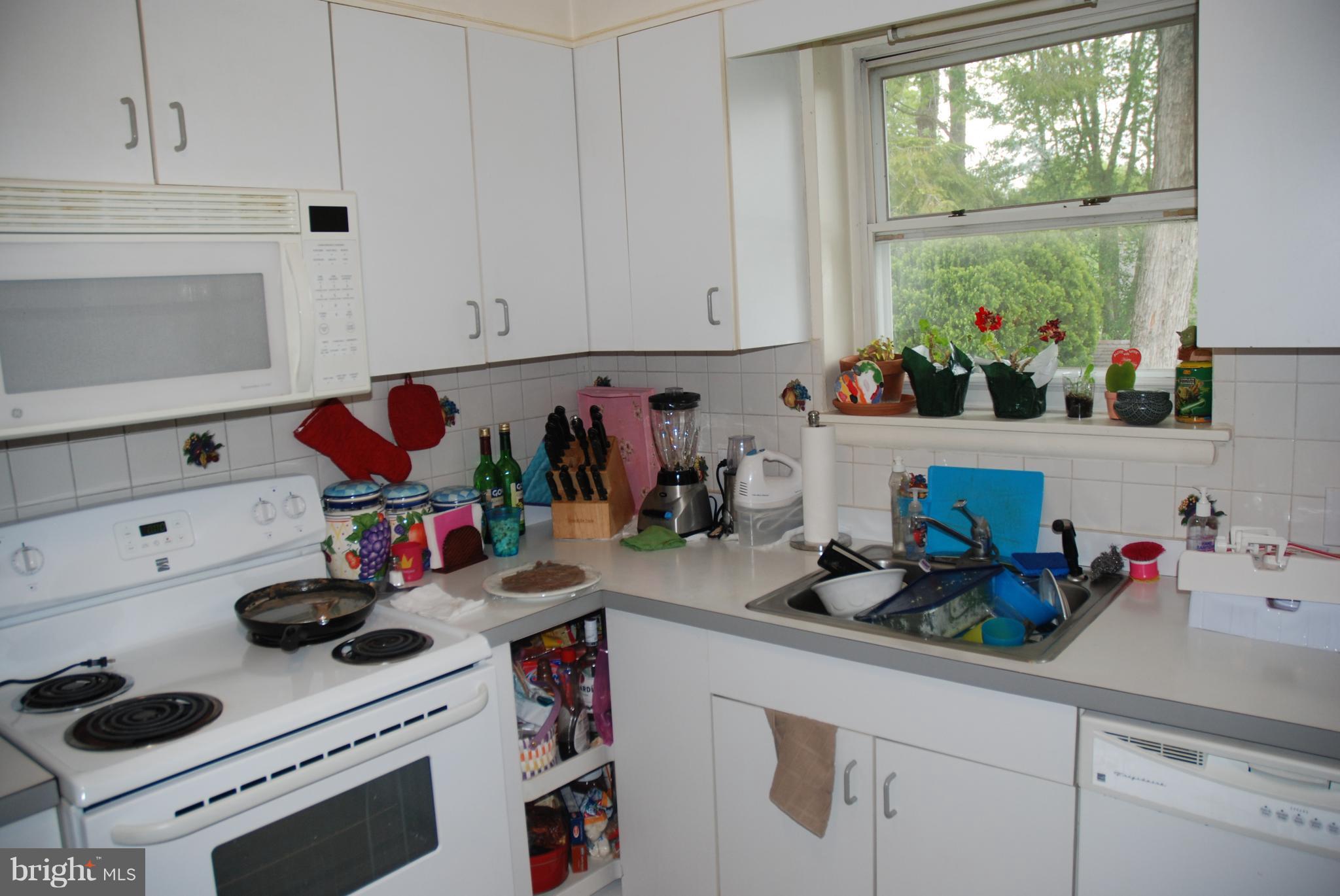 12603 Bluhill Road Silver Spring, MD 20906 - Photo 8 of 21 a kitchen with a stove and cabinets