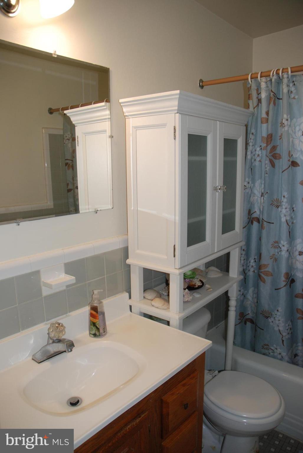 12603 Bluhill Road Silver Spring, MD 20906 - Photo 9 of 21 a bathroom with a sink toilet vanity and shower