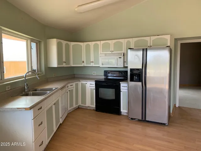 a kitchen with a sink stove and refrigerator