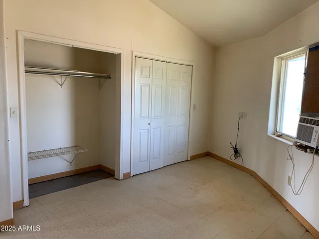 a view of an empty room with closet area