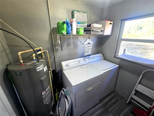 a utility room with dryer washer and a window
